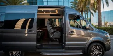 Luxury Mercedes Sprinter Van with open sliding doors parked in San Diego.
